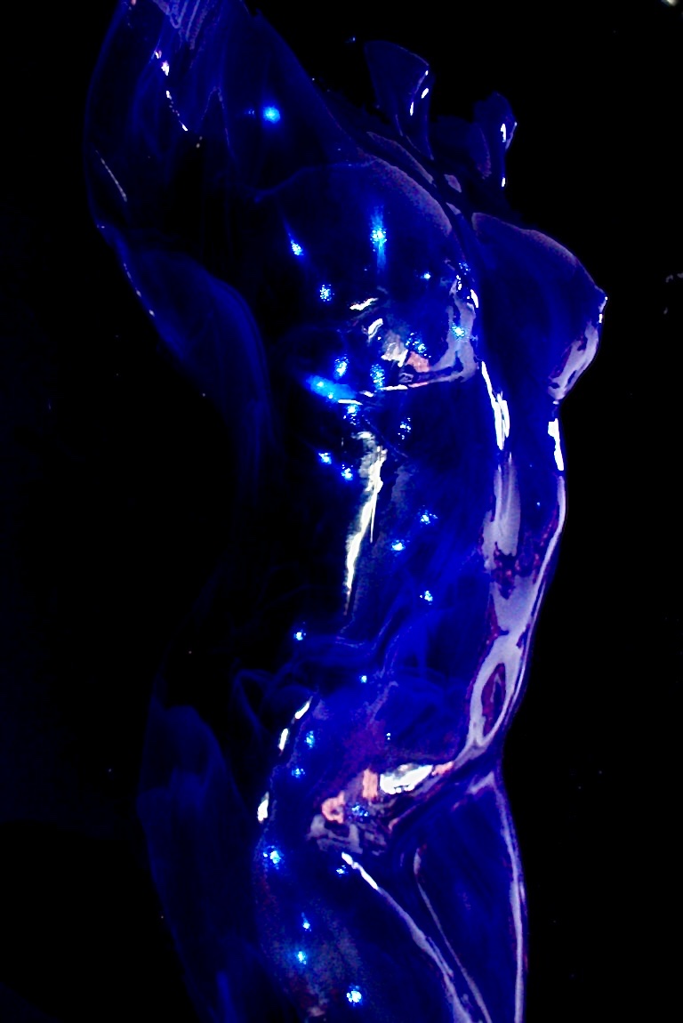 Luminous cobalt-blue fine-art nude torso dotted with sparkling highlights against black