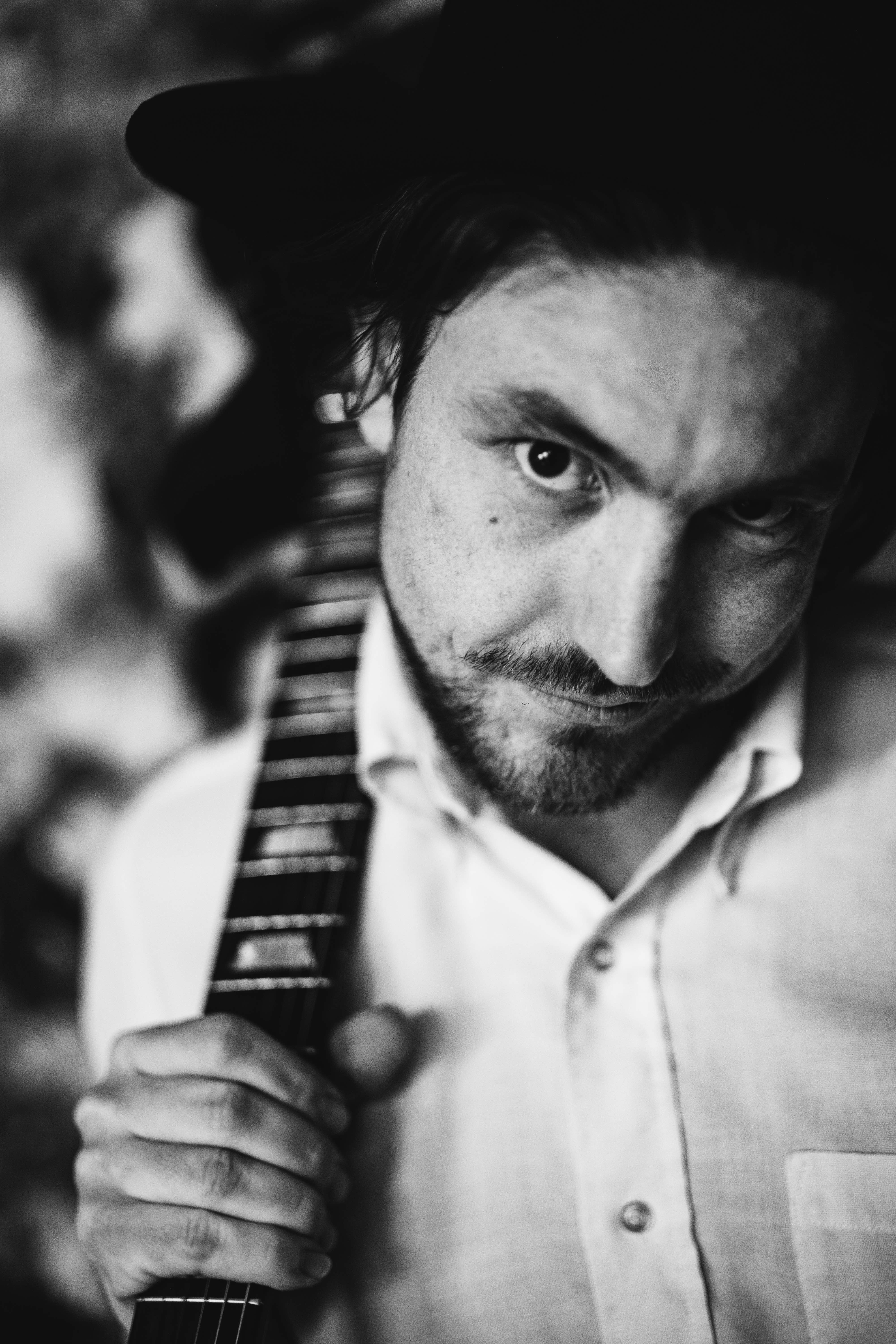 Portrait of Kyle Q. Daley holding a guitar